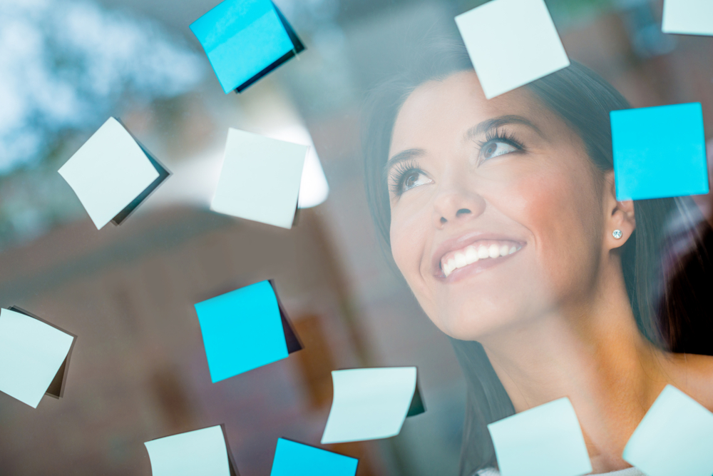Woman multitasking with posting post-its all over the place